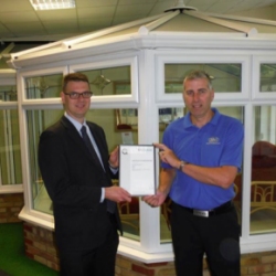 Simon Beer (left) presents Mark Page of R&M Windows & Conservatories with the first Q-Mark Conservatory Installation Scheme certificate